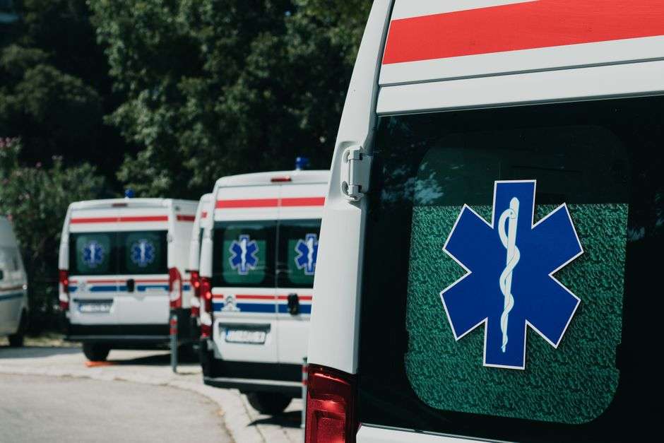 Ambulances parked at a staging area, similar to the emergency vehicles operated by Mobile Fire-Rescue