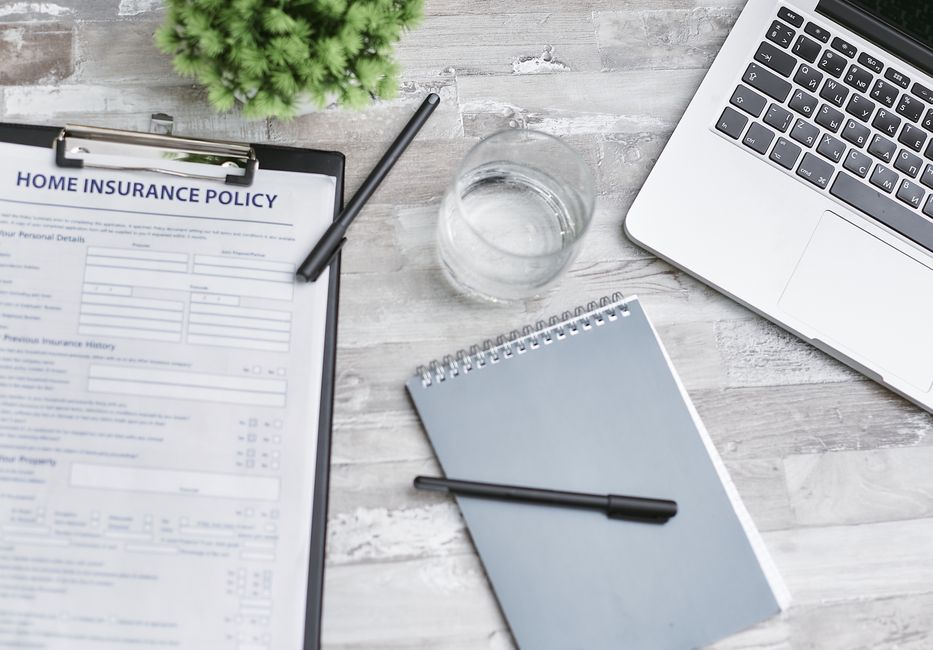 Insurance documents and a pen on a desk