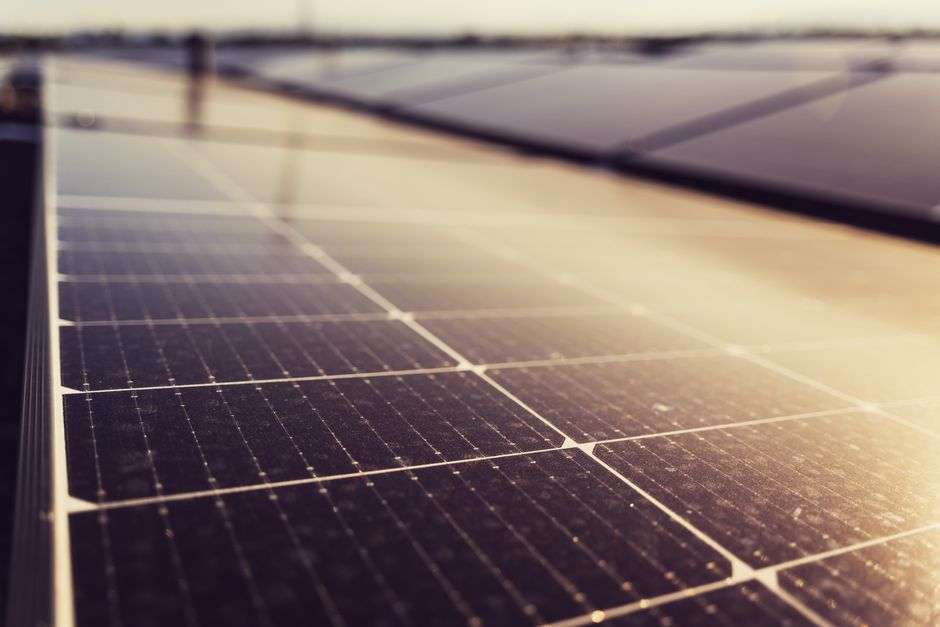 Rows of solar panels in sunlight, illustrating renewable-energy research