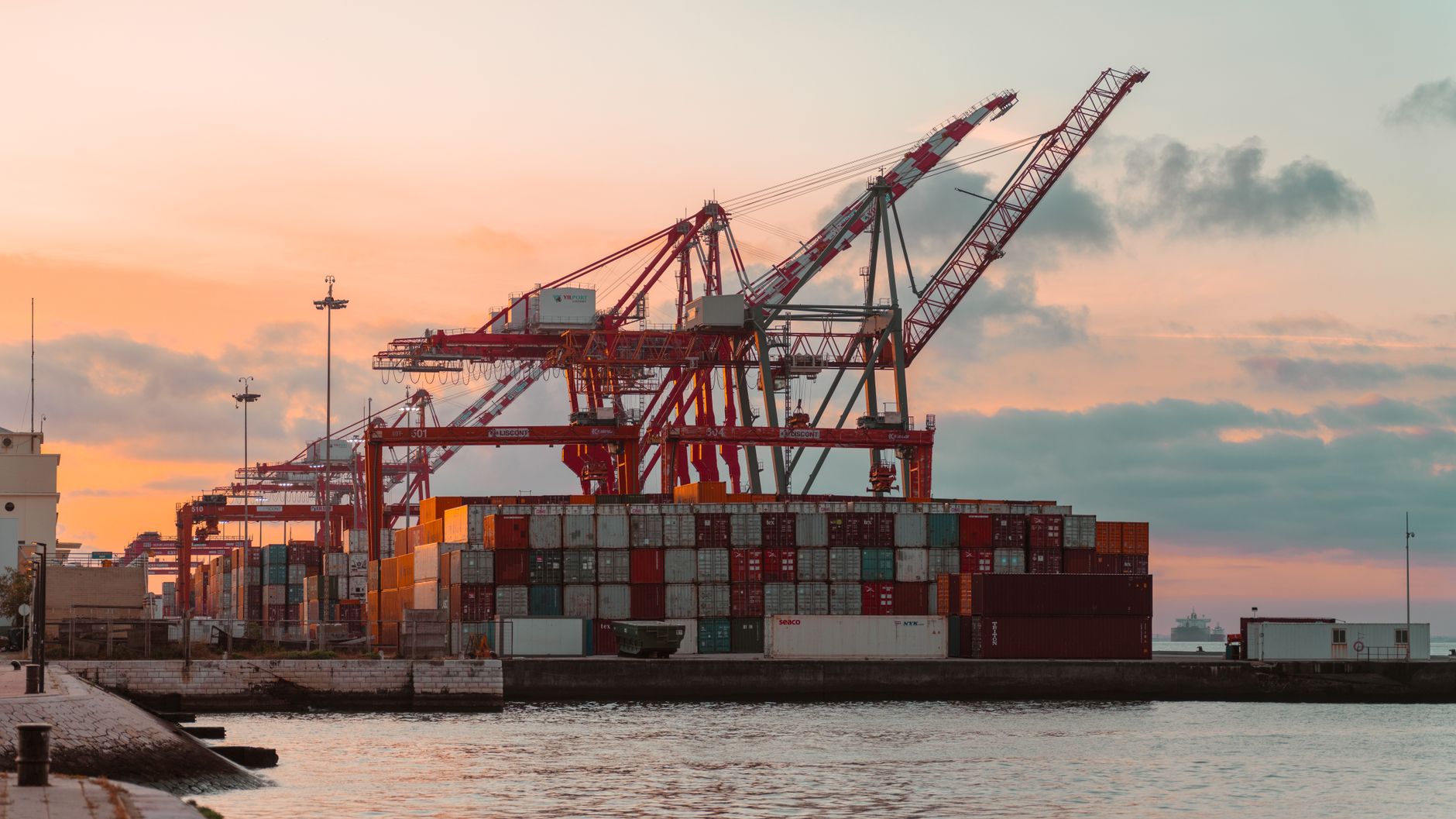 Cargo cranes and shipping containers at a seaport