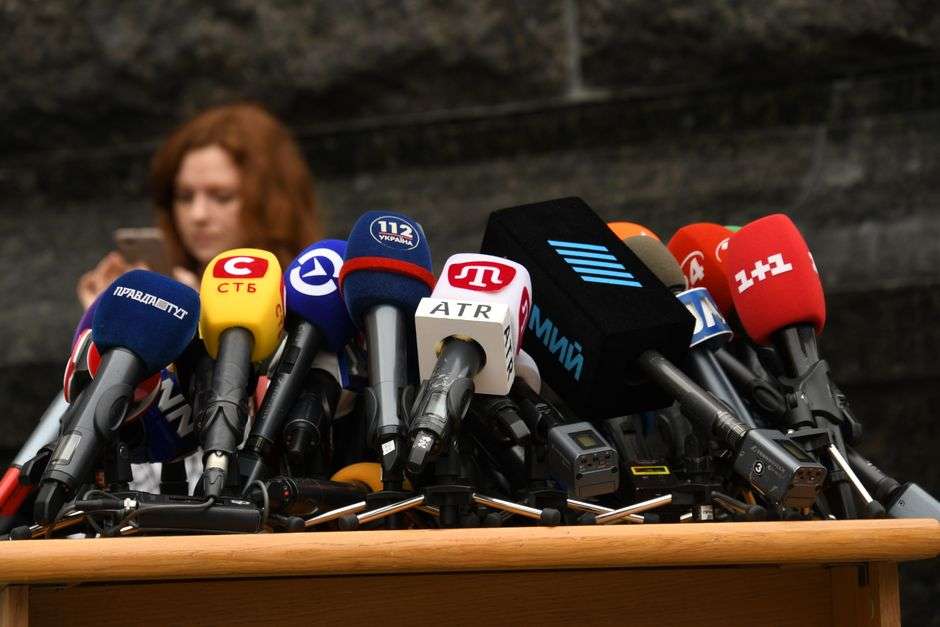 Microphones set up at a podium for a law enforcement press conference