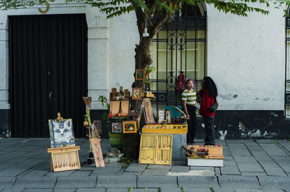 Artists and vendors set up booths at an outdoor art market
