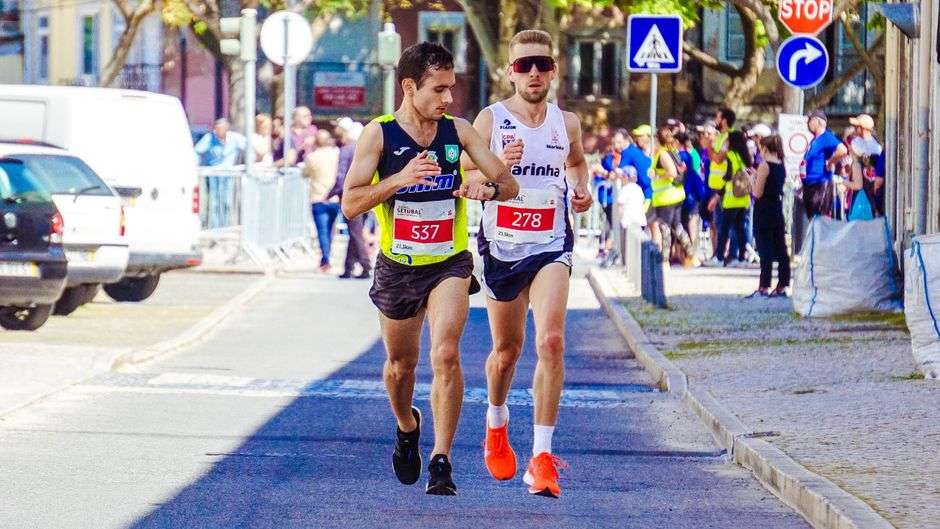 Marathon runners moving through a downtown street course