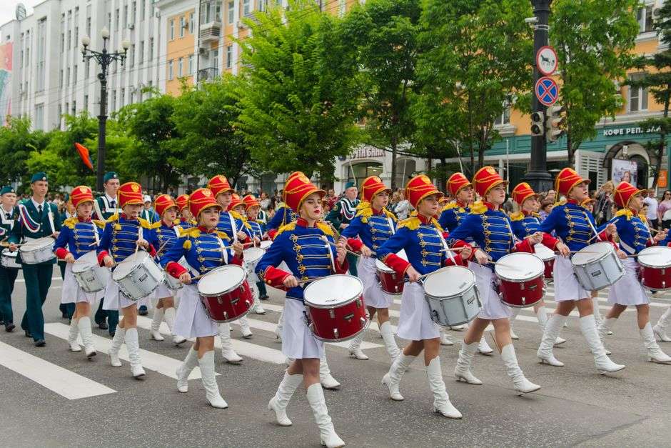 Young musicians marching with brass instruments in a parade