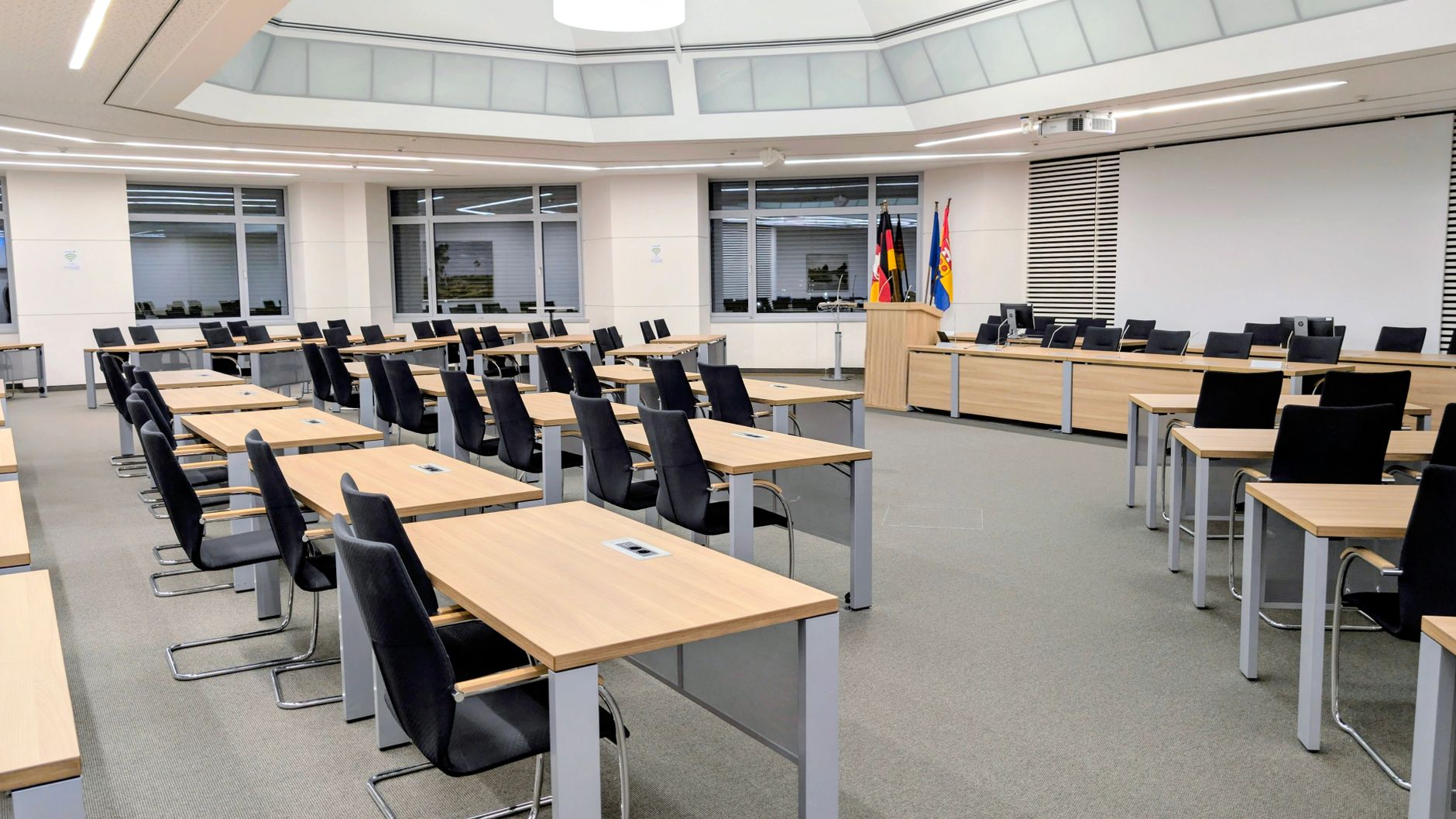 Government officials seated around a conference table in discussion