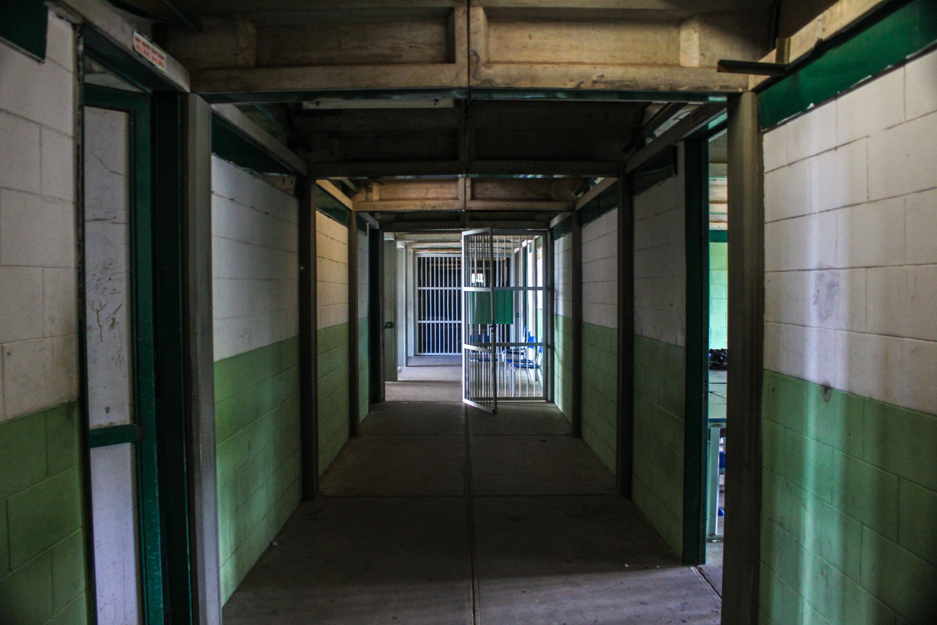 A row of jail cell bars along a corridor