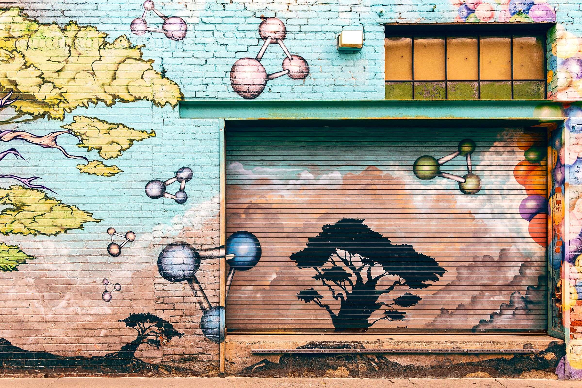 A colorful collaborative mural painted on a wall, similar to the group canvas art created at a Mobile art party