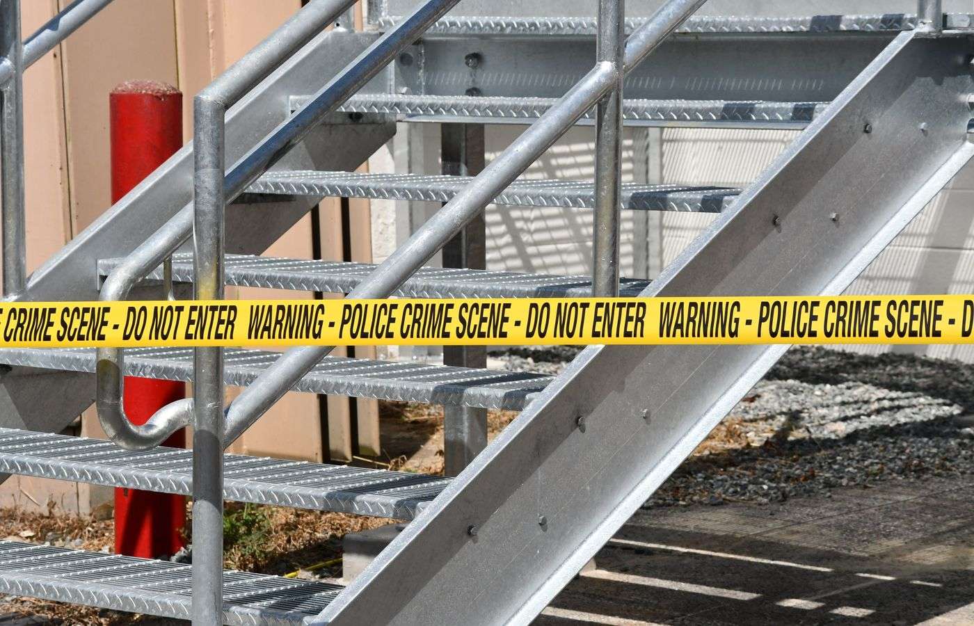 Yellow police crime scene tape stretched across an investigation area