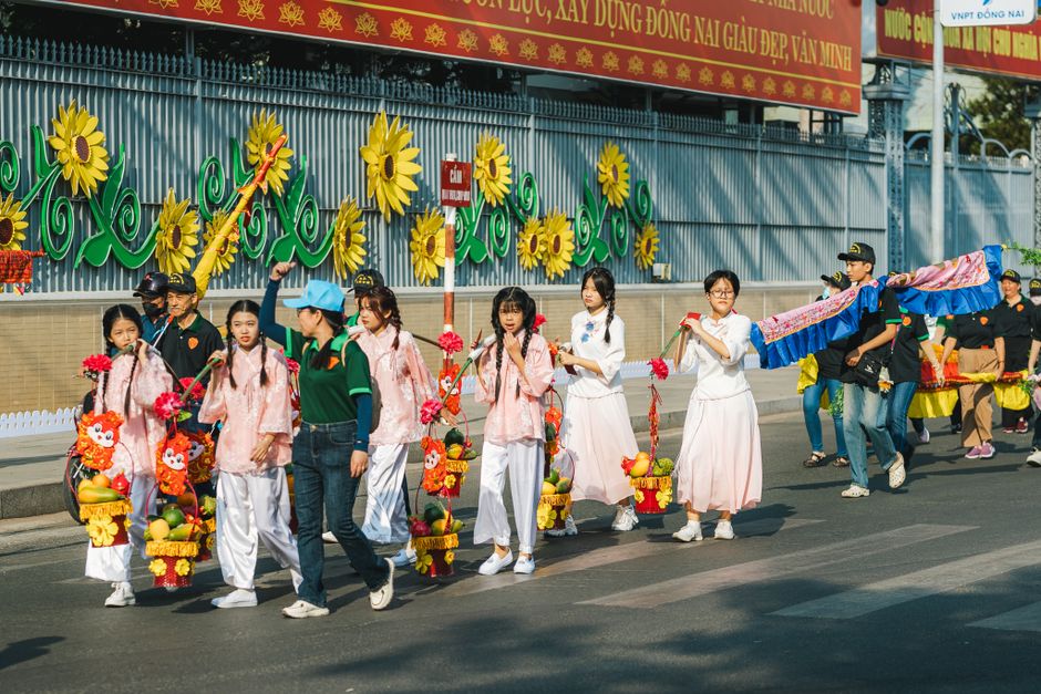 Children marching in a homemade float parade during a Mardi Gras celebration