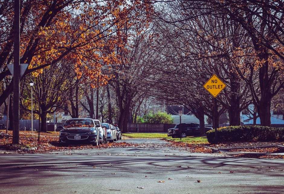 A residential street marked with a no outlet sign, similar to neighborhood streets involved in closure disputes