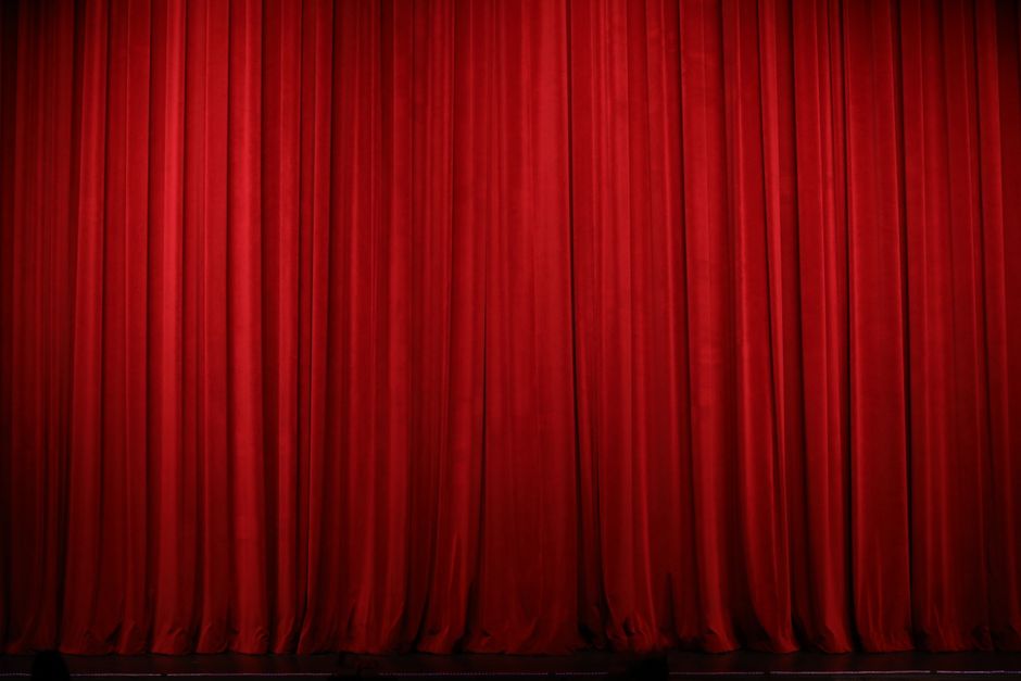 Empty opera theater stage with red curtains