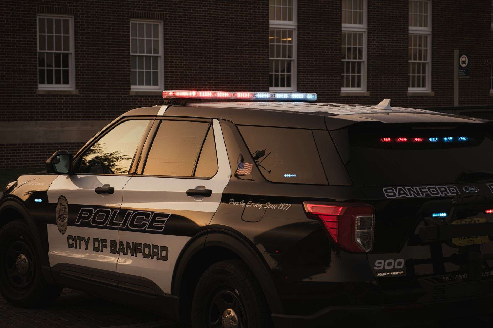 Police patrol vehicle with emergency lights illuminated at dusk