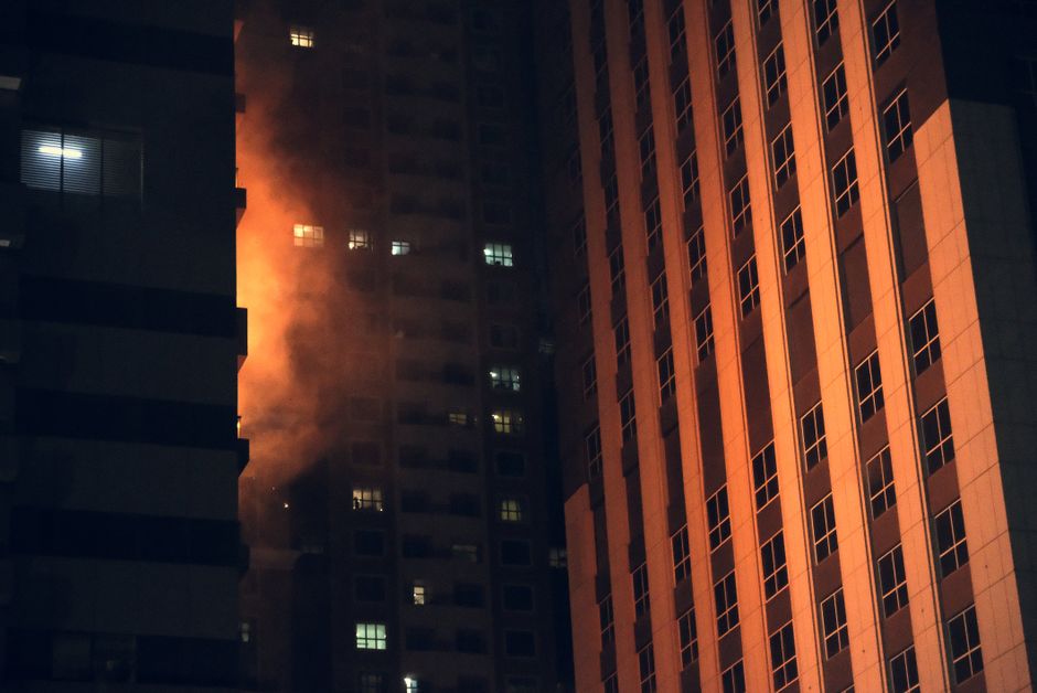 Emergency response lights at a nighttime apartment fire in Mobile