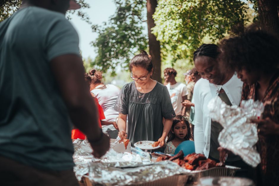 People gathered outdoors at a community cookout event