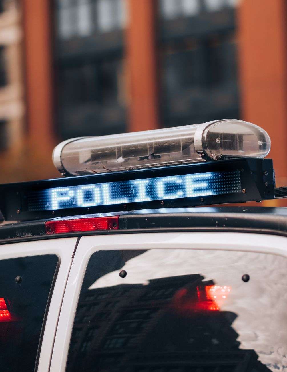 Police patrol car with flashing lights responding at night