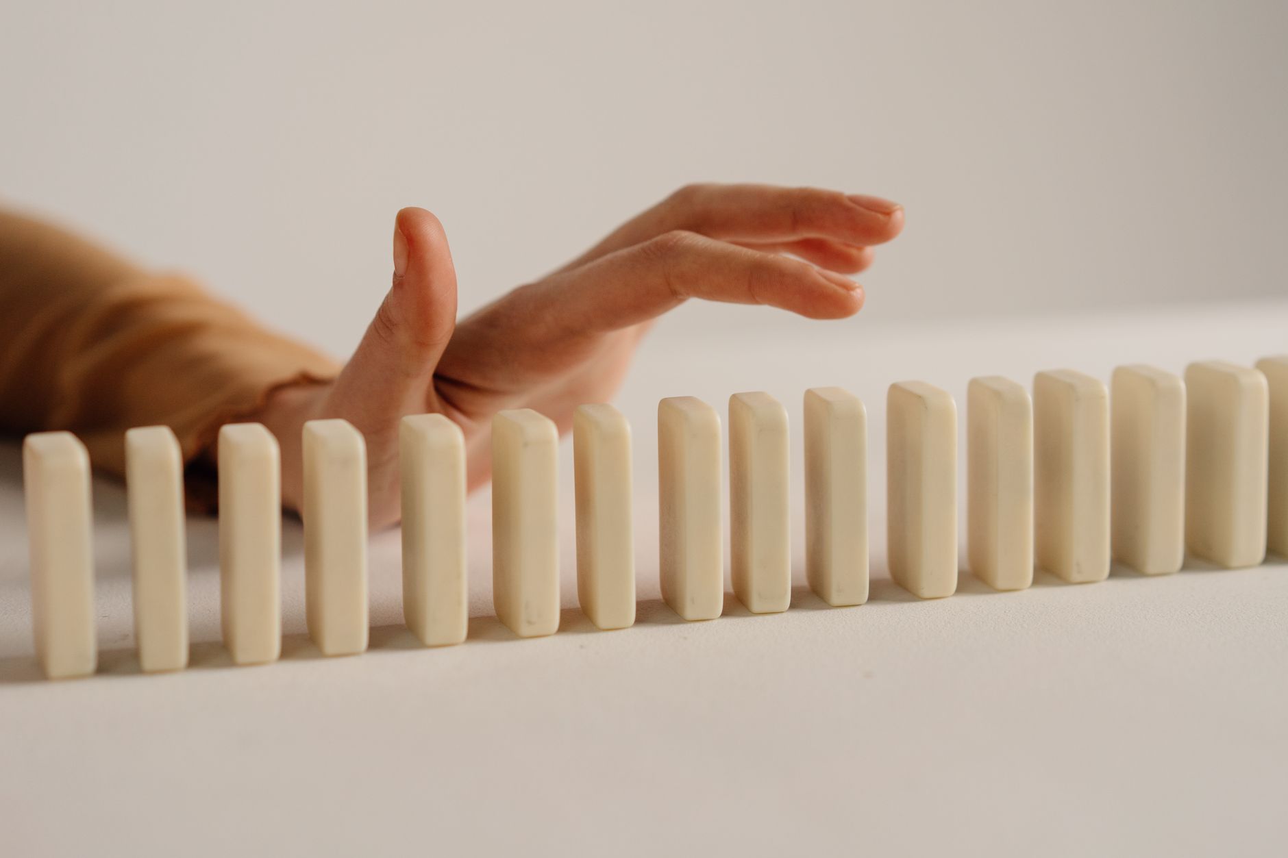 A row of dominoes beginning to topple in sequence