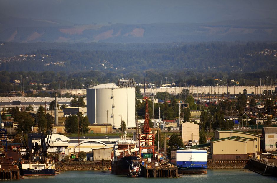 Above-ground industrial storage tanks near a waterfront