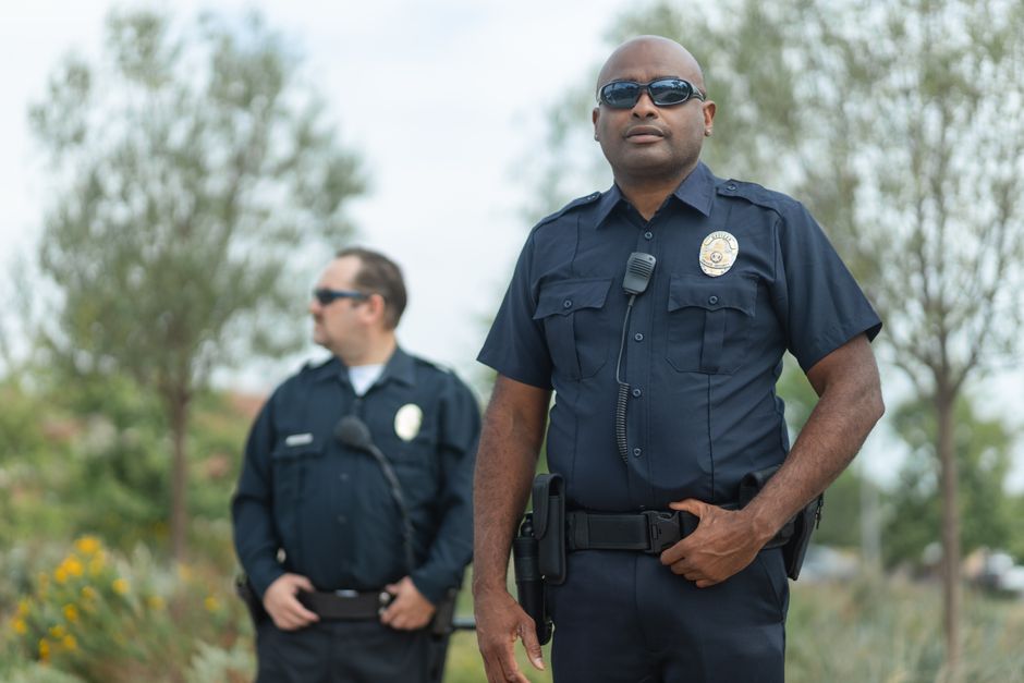 Police officer working with a school resource officer on campus safety