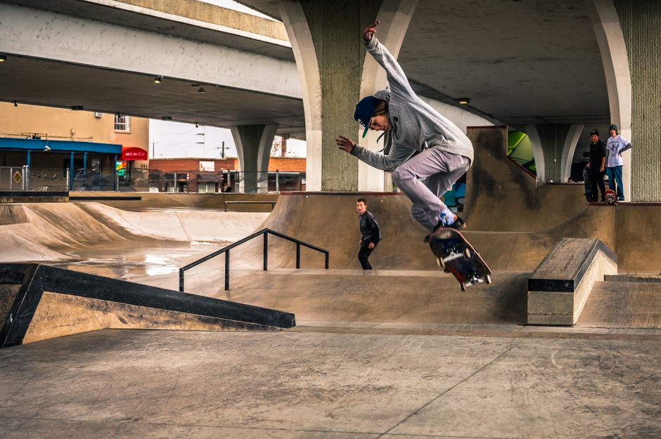Skateboarder riding a ramp at a public park