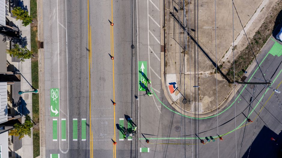 A group of cyclists riding in a painted bike lane on a city street