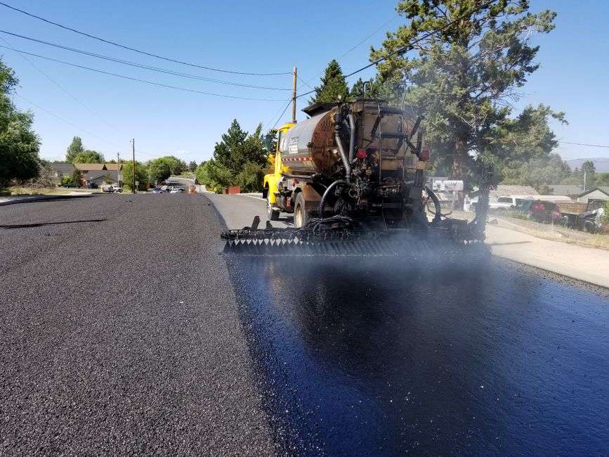 Fresh asphalt is laid down during a street repaving project in Mobile