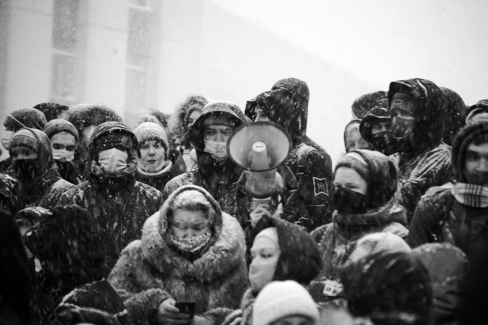 Political campaign volunteers holding signs on a cold winter street
