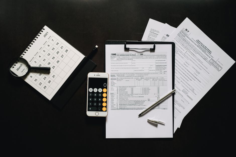 Tax forms and a calculator on a desk