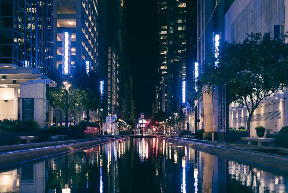 Downtown city street illuminated at night