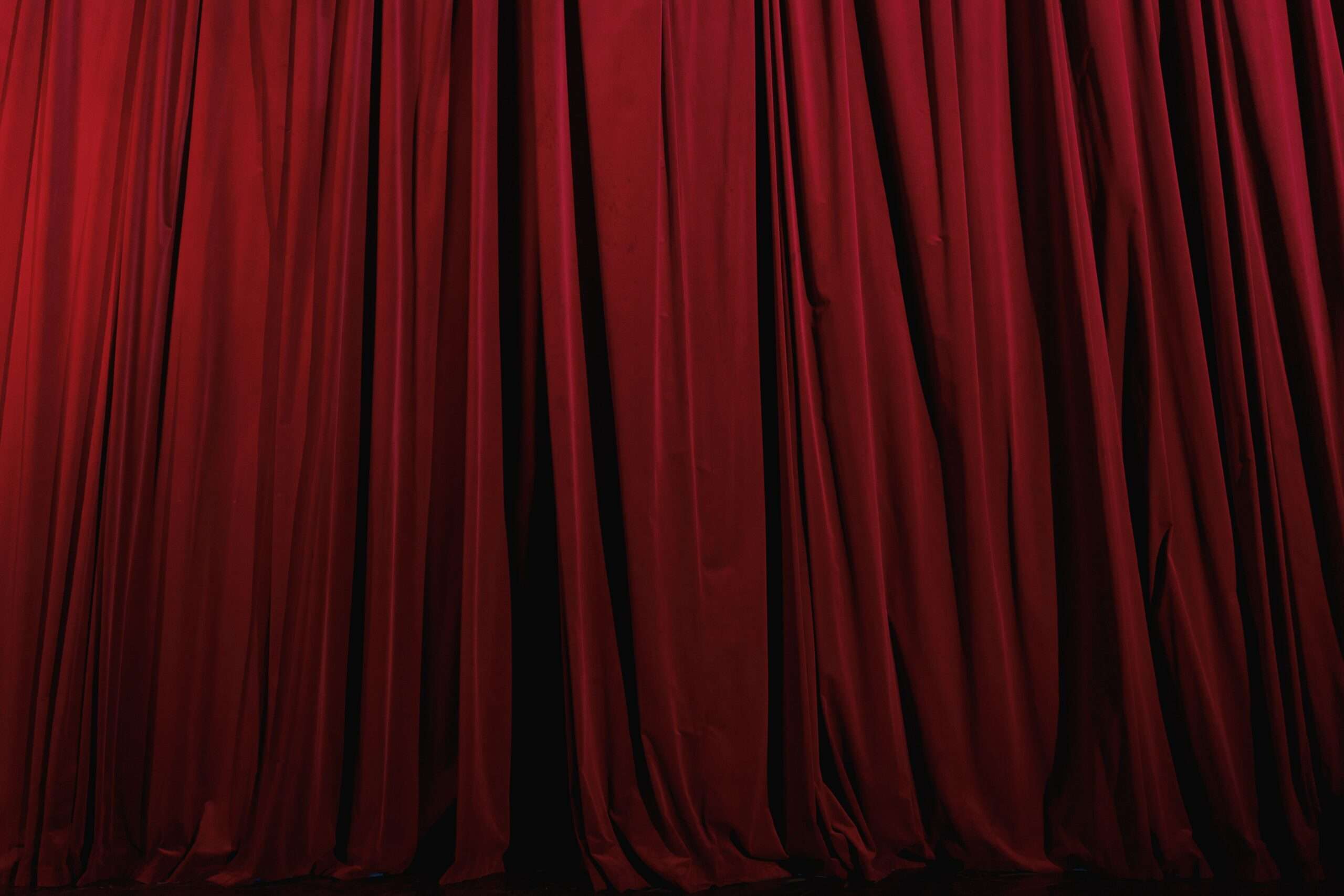 A red pleated theater stage curtain