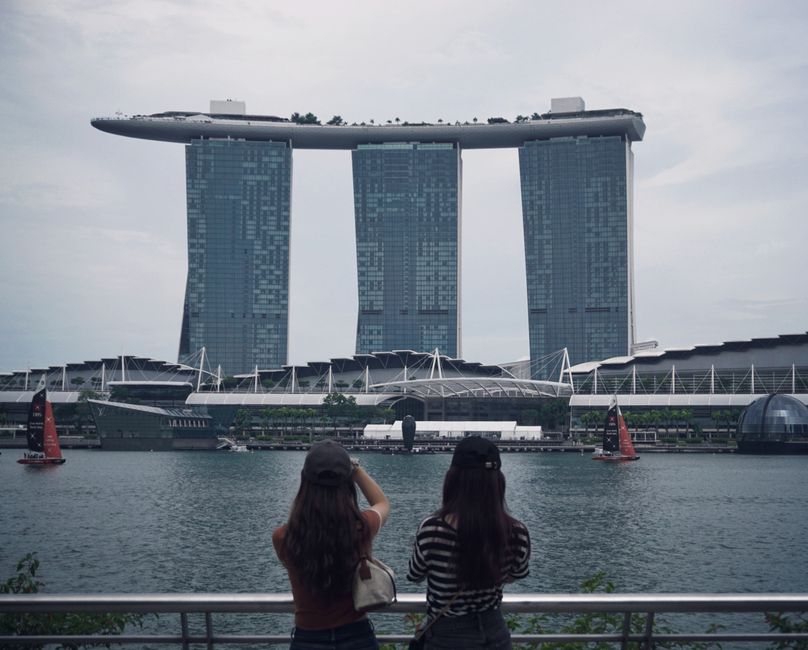 Visitors walking along a scenic waterfront downtown area
