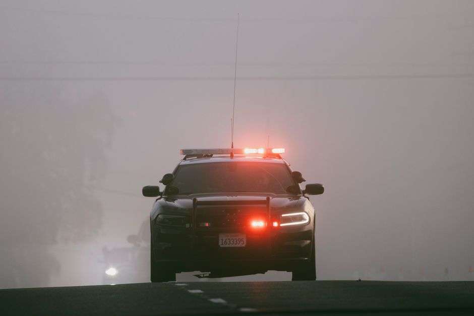 Police emergency lights illuminated at night during an active investigation