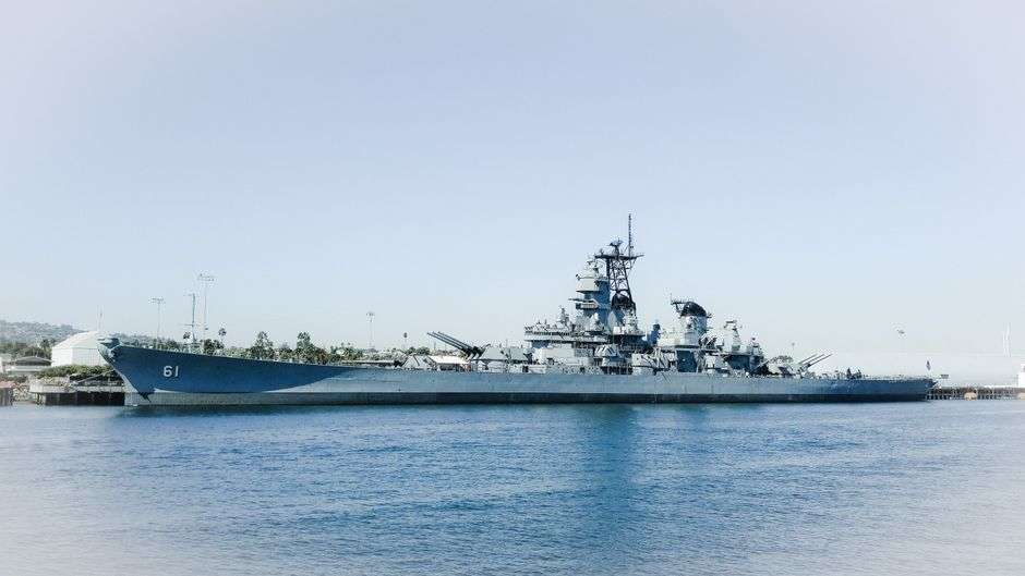 A retired battleship moored at a memorial museum park