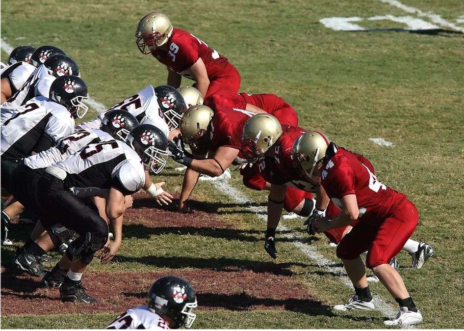 Offensive linemen face off at the line of scrimmage during a college football game