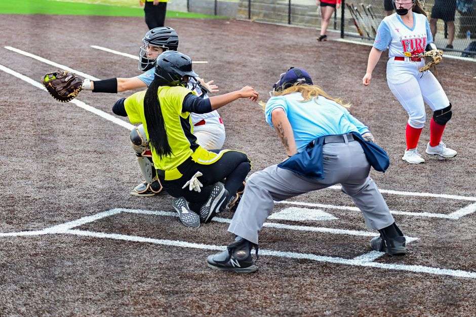 A softball player slides into a base during a high-intensity championship game