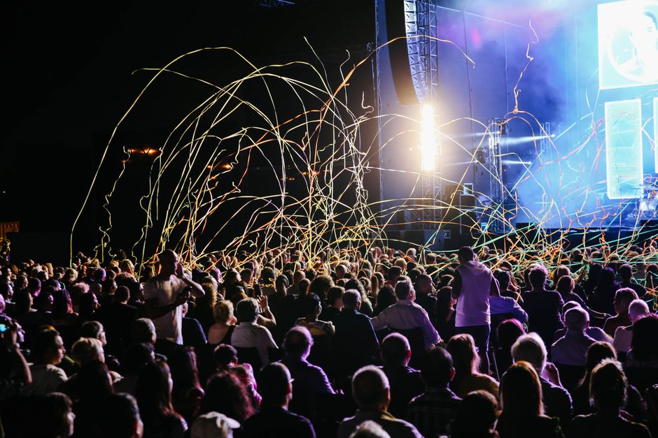 Crowd gathered at an outdoor amphitheater concert venue