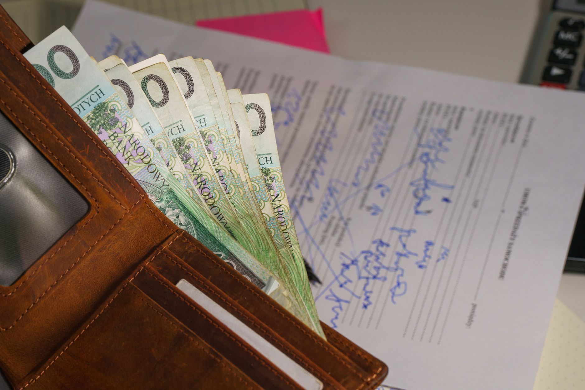A loan document being signed at a desk