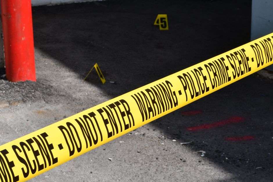 Police crime scene tape restricts access at an investigation site
