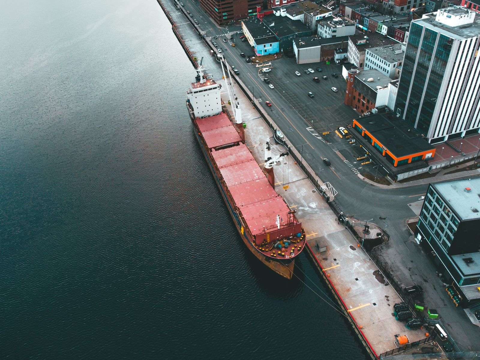 A large cargo ship docked at a commercial shipping port