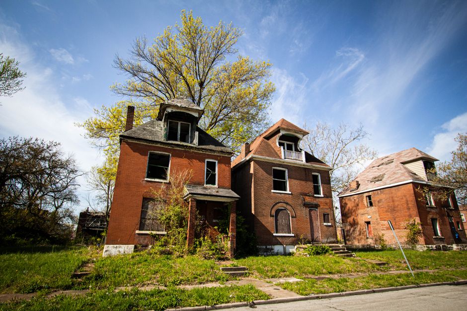 Abandoned, overgrown house marked for demolition