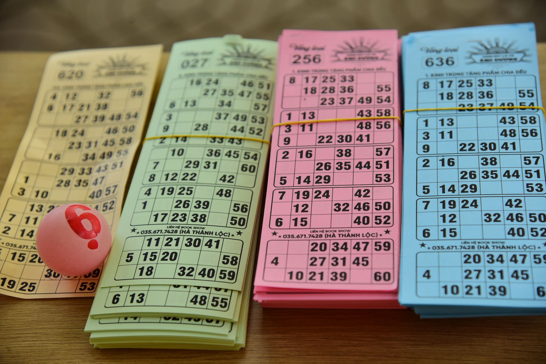 Bingo cards and numbered balls on a table