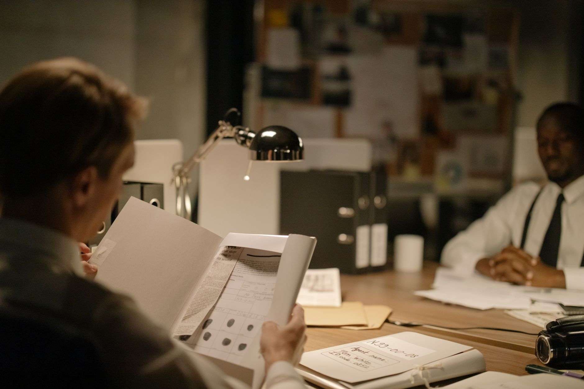 Investigators reviewing case documents and evidence during a criminal investigation