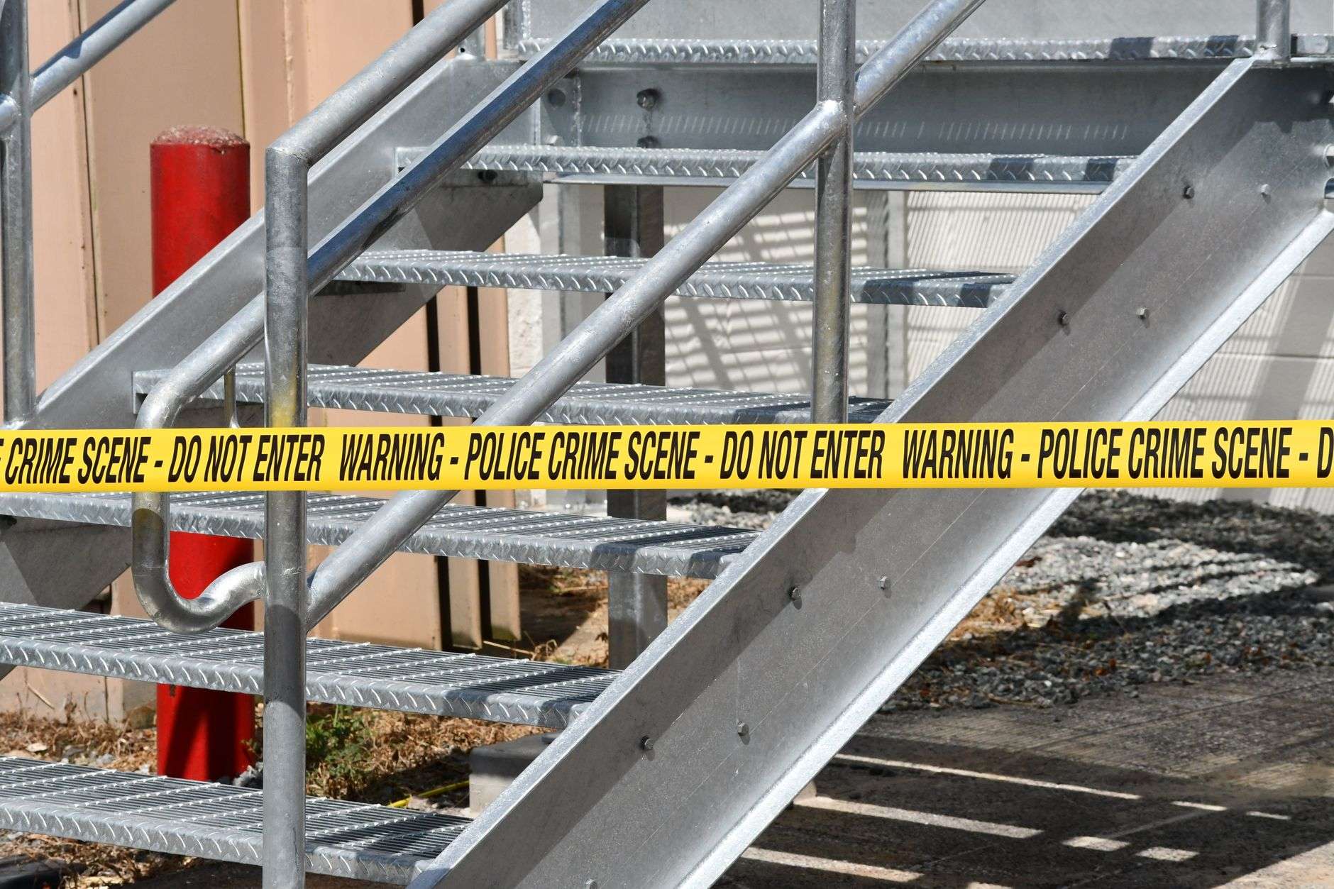 Yellow police crime scene tape at an investigation site