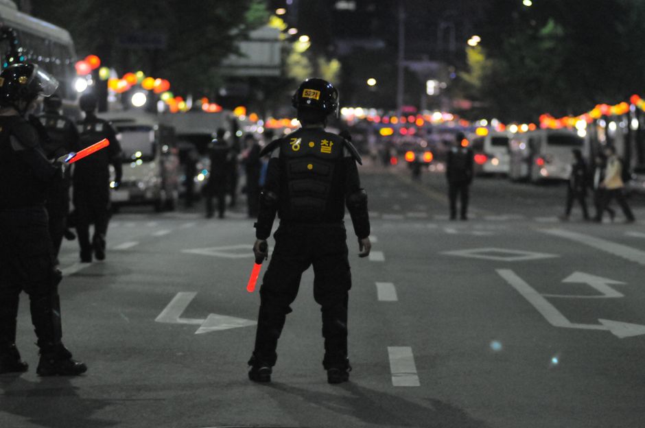A police officer patrolling a city street in the evening