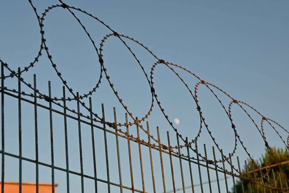 Barbed wire security fence surrounding a state correctional facility