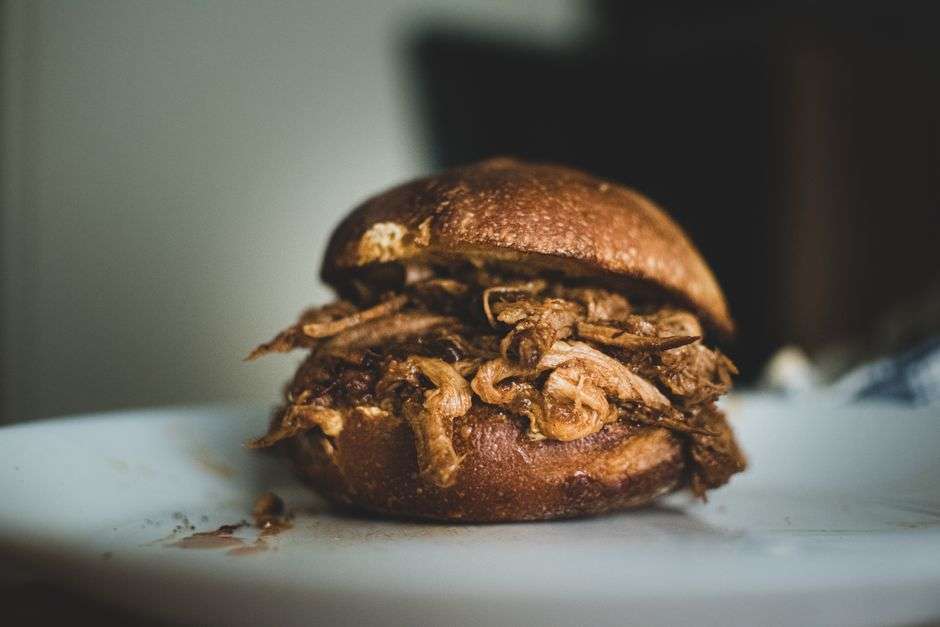 A pulled pork sandwich and barbecue plate served at a local restaurant