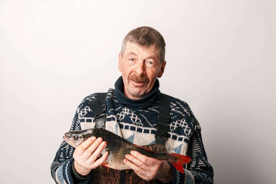 An angler holds up a freshly caught redfish near the Alabama Gulf Coast