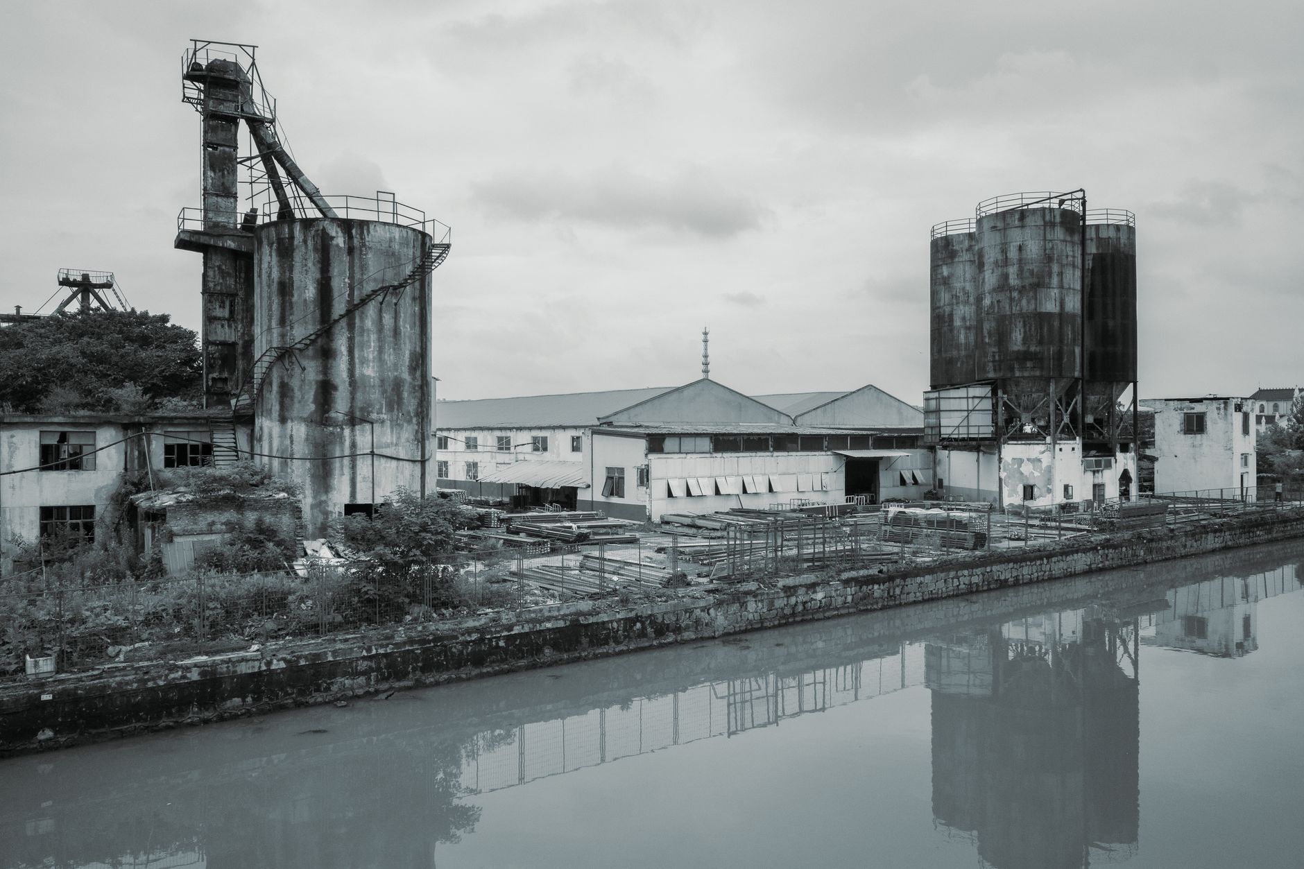 Heavy industrial steel plant beside a river at dusk