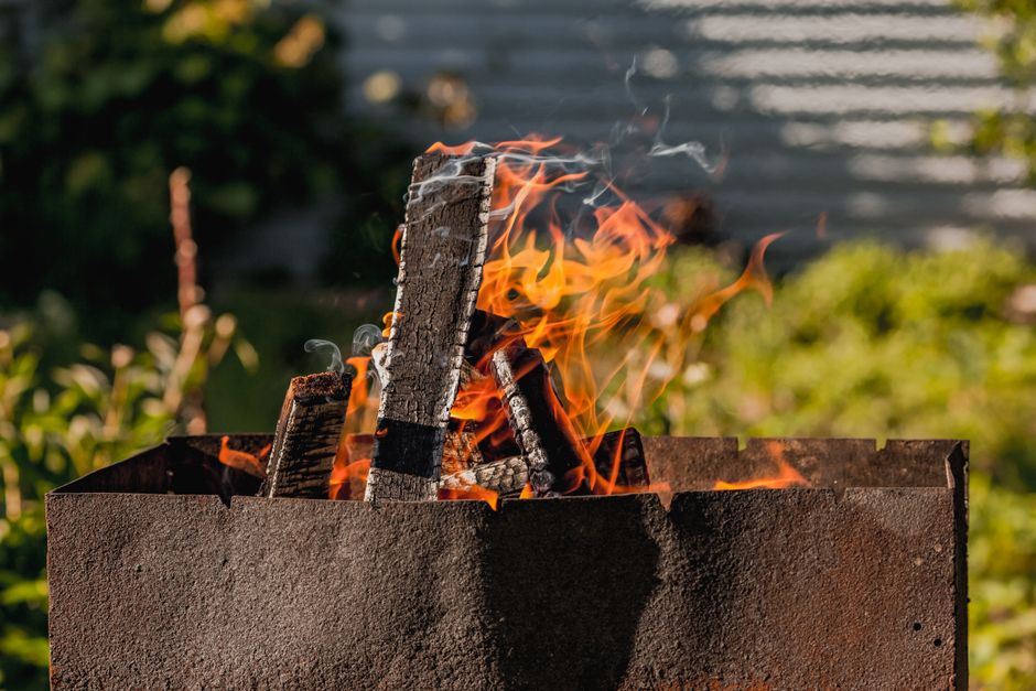 Smoke rising from an outdoor yard fire