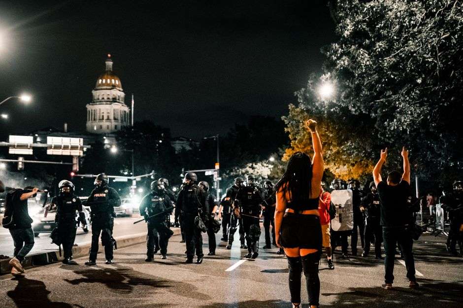 Flashing police lights at the scene of a law enforcement standoff at night