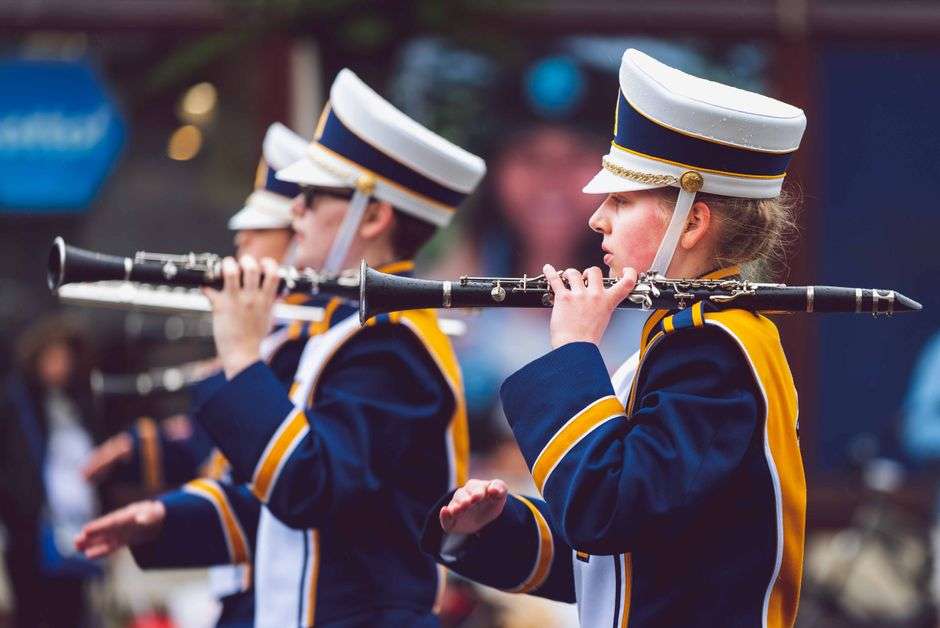 High school marching band clarinet players performing in uniform